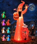 Tall glowing ghost inflatable with a pumpkin and a tombstone beside a woman, with light mode samples