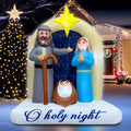 Nativity inflatable with Joseph, Mary and the baby under an arch with a gold star and an O holy night banner