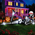 Giant skeleton inflatable lounging on a lawn in front of a purple-lit house