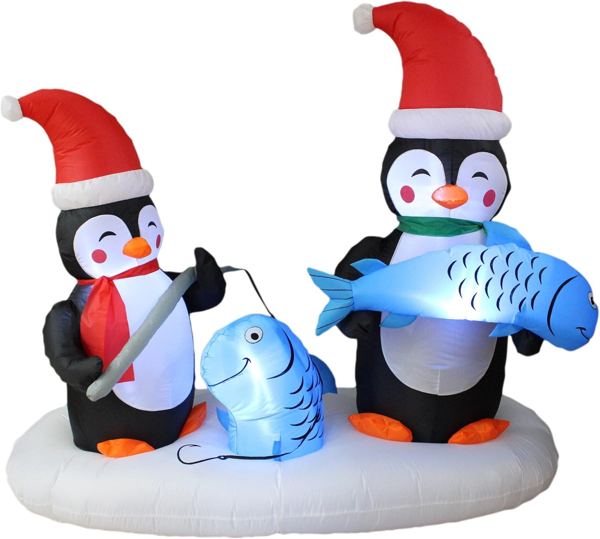 Two penguins in Santa hats ice fishing on a snowy base, one holding up a blue fish