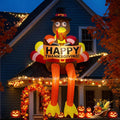 Tall turkey inflatable in a pilgrim hat holding a Happy Thanksgiving sign in front of a house at dusk