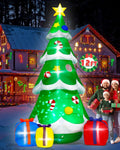 Tall green Christmas tree inflatable with candy canes and a gold star beside a family with gifts