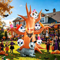 Orange haunted tree inflatable with sugar skulls in the branches and a gray skeleton dog, kids in costume nearby
