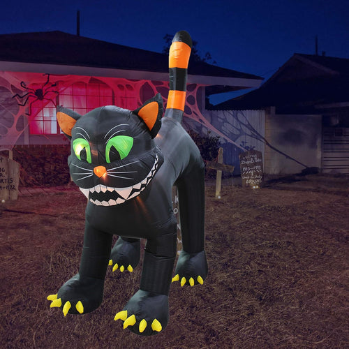 Giant black cat inflatable with an arched back, green eyes and sharp teeth at night